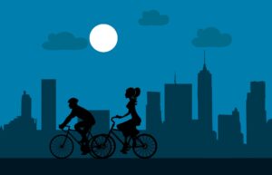 Cartoon of two people cycling at dusk