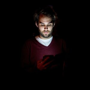 Man with phone in the dark