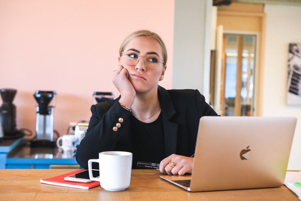 Women at desk suffering procrastination